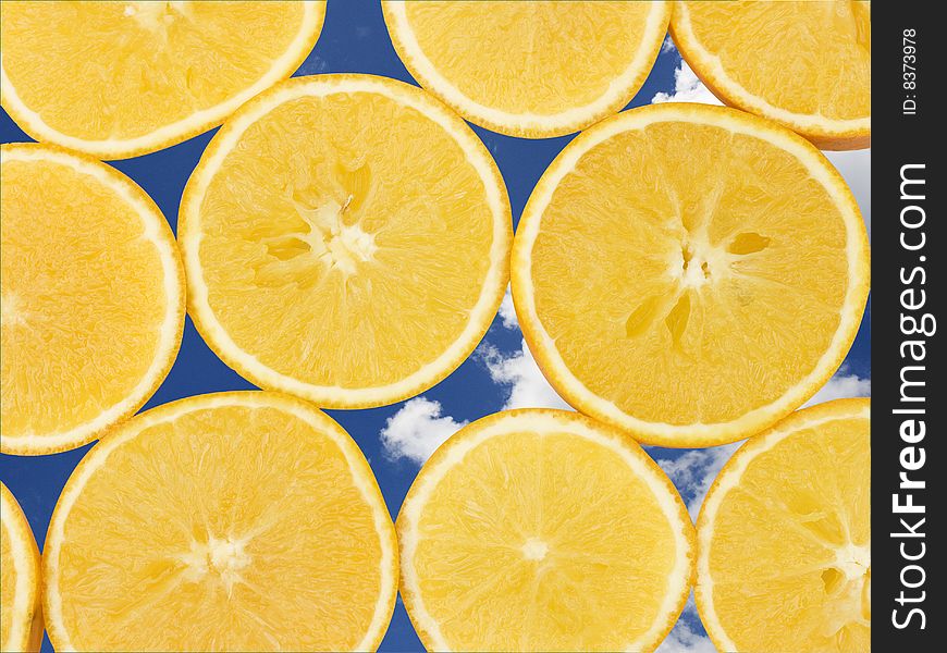 Fresh orange slices, laid out to form a pattern. The background is of a sky on a sunny day. This has been used to emphasis freshness. Fresh orange slices, laid out to form a pattern. The background is of a sky on a sunny day. This has been used to emphasis freshness.
