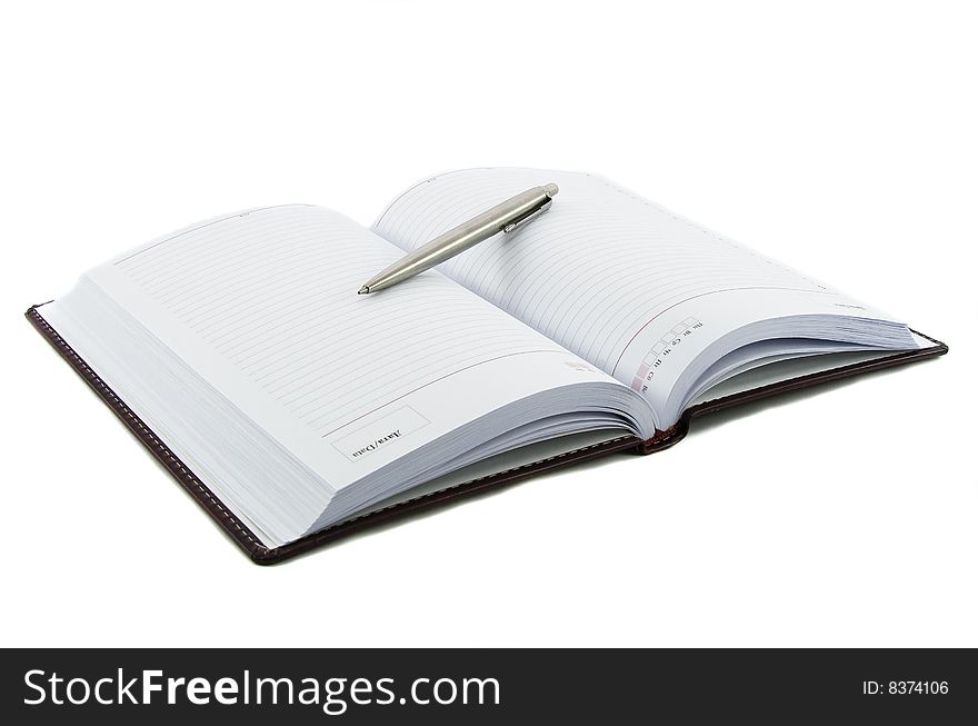 Close up notebook and pen on it isolated over white