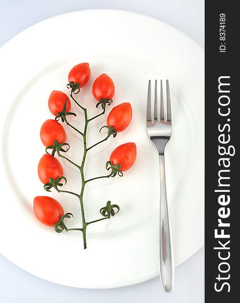 fork and small tomatoes on the Plate
