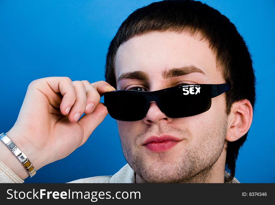 Young man with sexy look over blue background