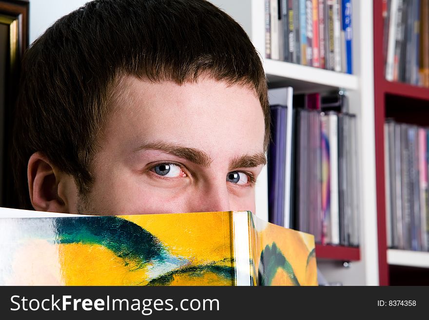 Portrait of smart man against the bookshelves. Portrait of smart man against the bookshelves