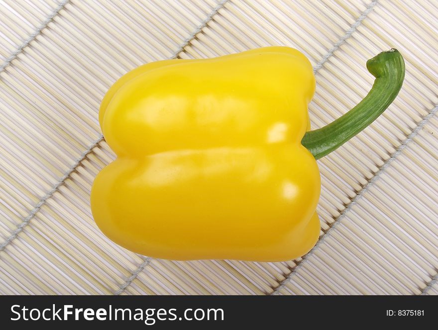 Yellow pepper on mat.