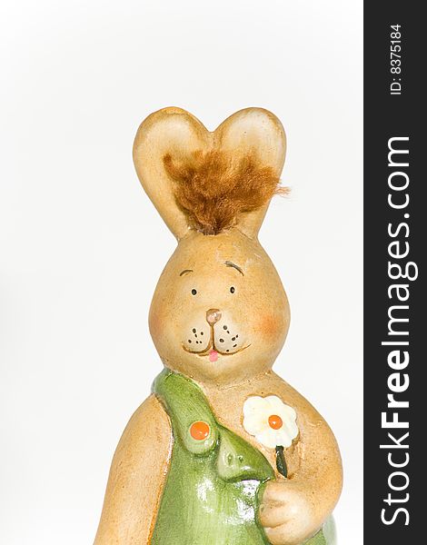 Easter-bunny with flower in front of a white background