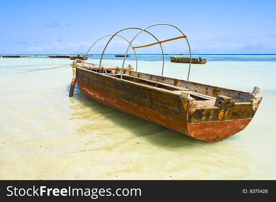 Horizontal ocean landscape with fishing boats by Zanzibar coast