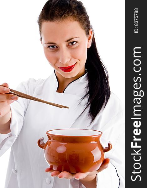 Woman chef with chopsticks and porcelain pot