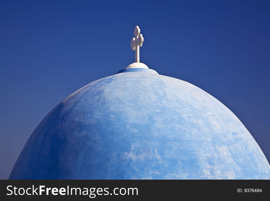 A beautiful blue domed church on the island of Santorini, Greece. A beautiful blue domed church on the island of Santorini, Greece.