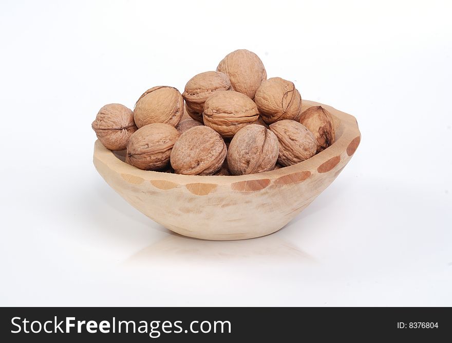 Lot of whole nuts in a dish maybe pot. Lot of whole nuts in a dish maybe pot