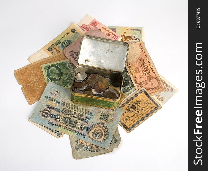 Old currency and metal box with old coins isolate