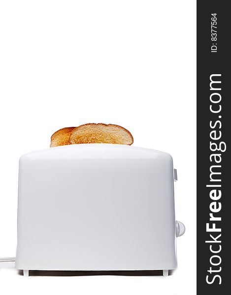 Toasted bread popping up from a white toaster. Toasted bread popping up from a white toaster