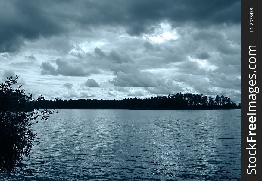Photo of Dark lake, island, trees
