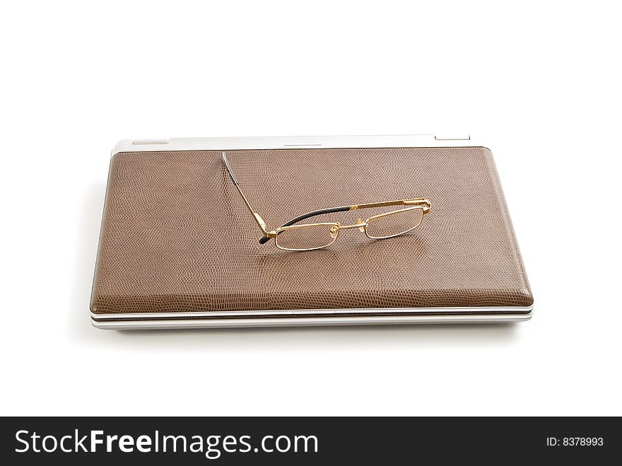 Laptop, note book and glasses isolated on white