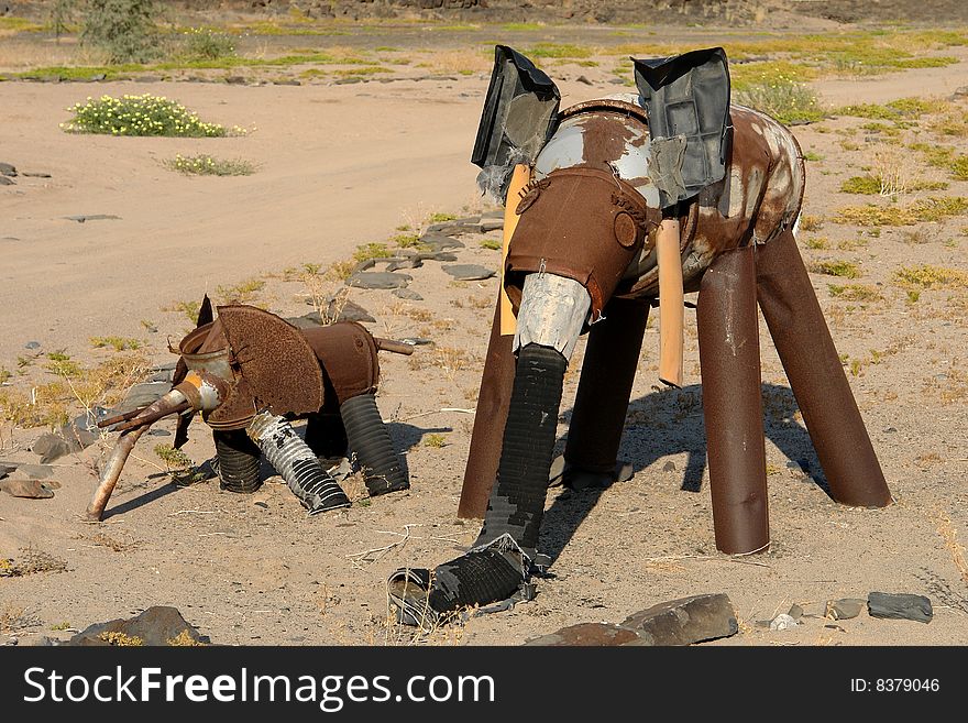 Little elephant with mother as a toy of iron