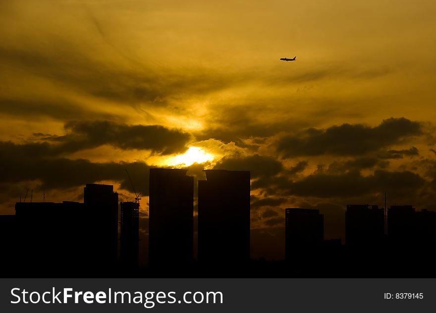 Plane flying above the Makati Central Business District during sunrise. Plane flying above the Makati Central Business District during sunrise