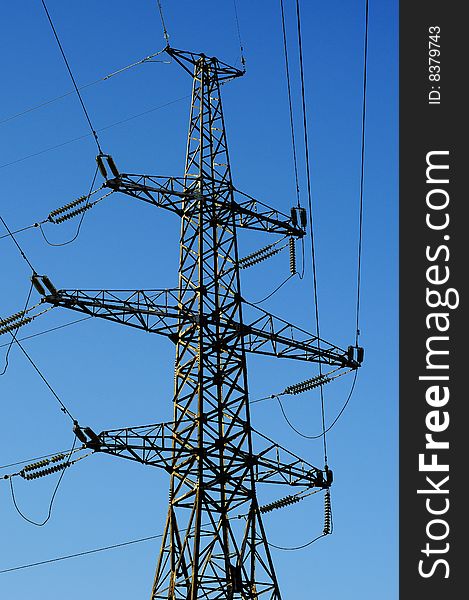 Power transmission line on tower. Line corner on blue sky. Power transmission line on tower. Line corner on blue sky.