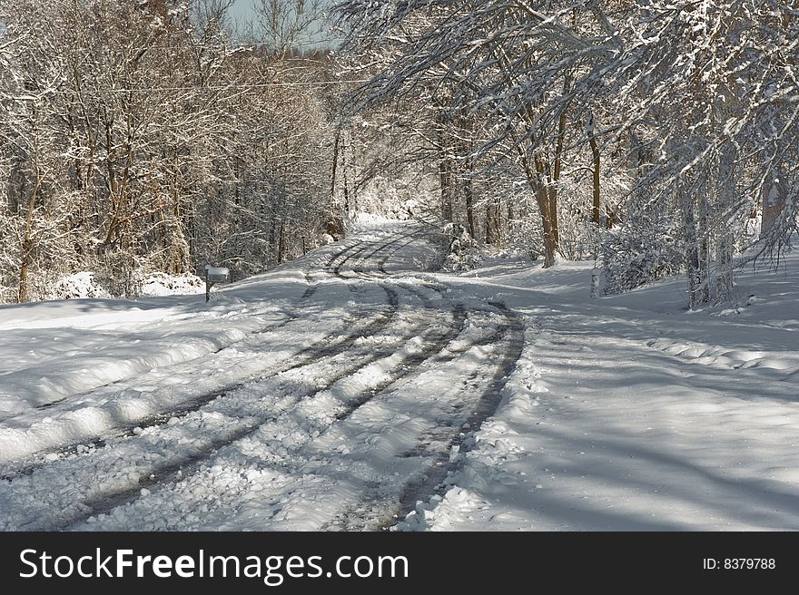 A winding country road with snow and tracks in rural Tennessee. A winding country road with snow and tracks in rural Tennessee.