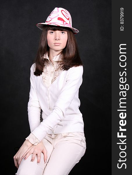 Pretty girl sitting on a chair in studio