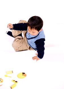 Boy Piecing Picture Together Stock Photo