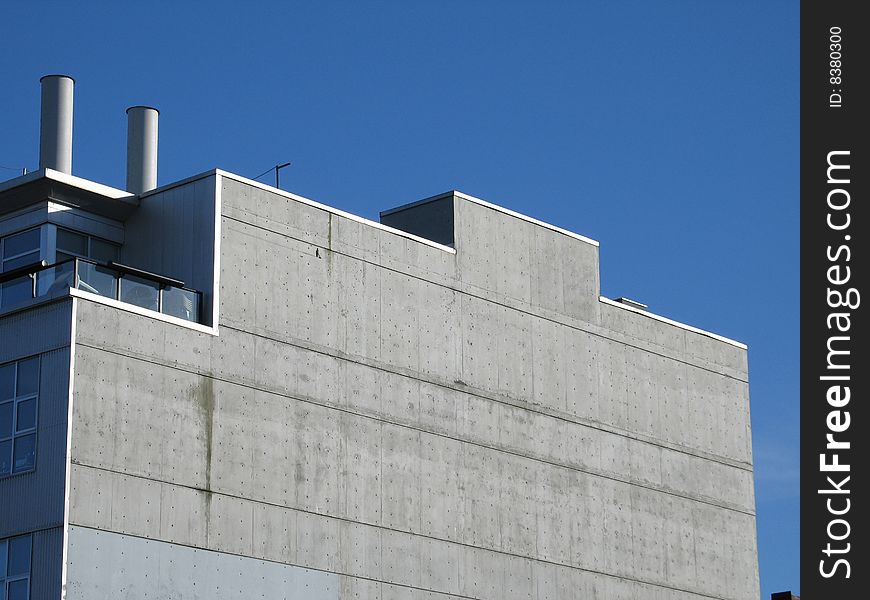Modern concrete building with chimneys. Modern concrete building with chimneys