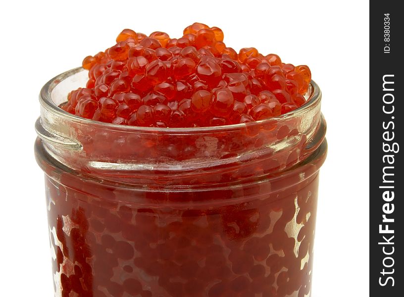 Red caviar into a glass jar isolated over white background. Red caviar into a glass jar isolated over white background