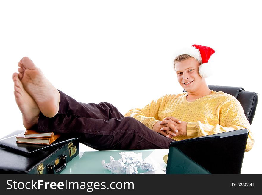 Relaxing male wearing christmas hat against white background