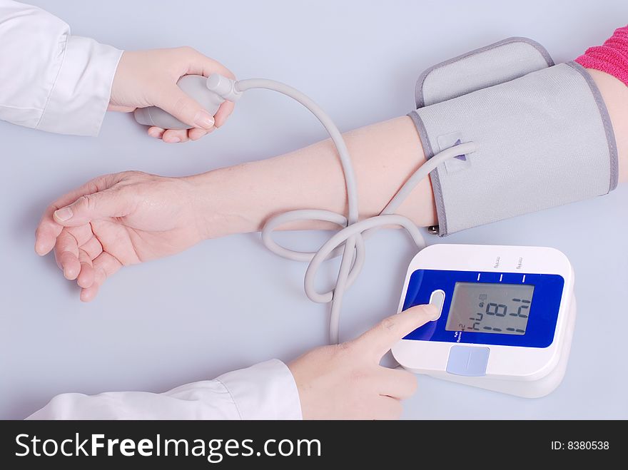 Nurse checking blood pressure of old-aged patient