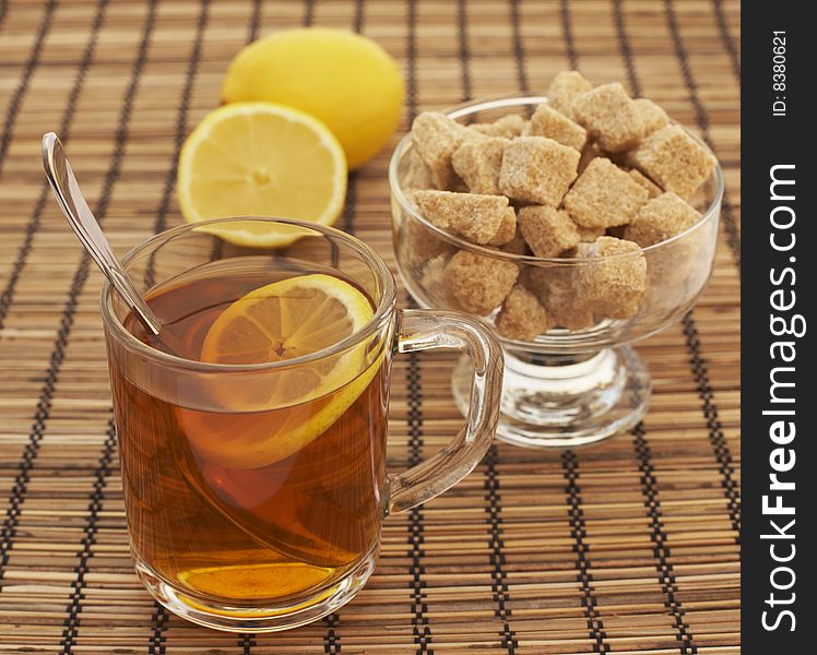 Tea with lemon and sugar on the textile background