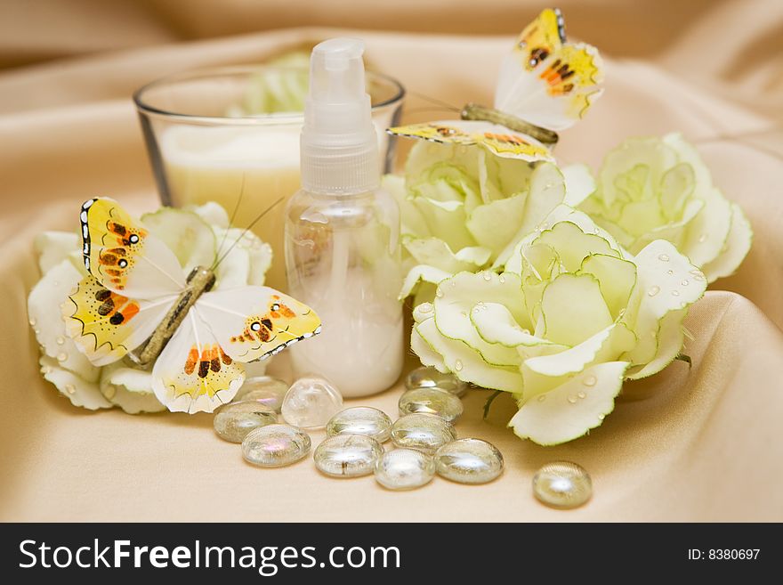 Bath accessories and roses on satin