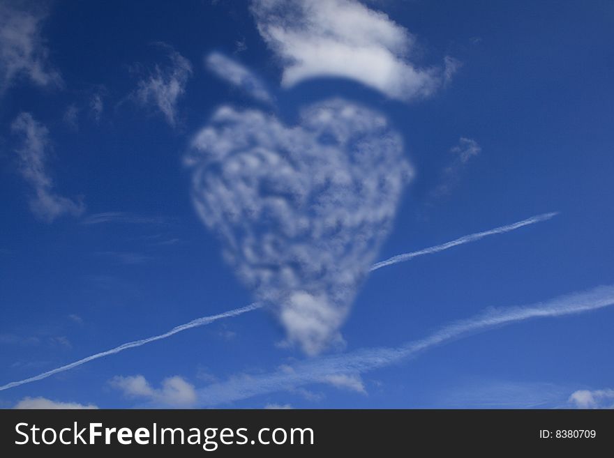 Heart from clouds on blue sky and plane traces. Heart from clouds on blue sky and plane traces