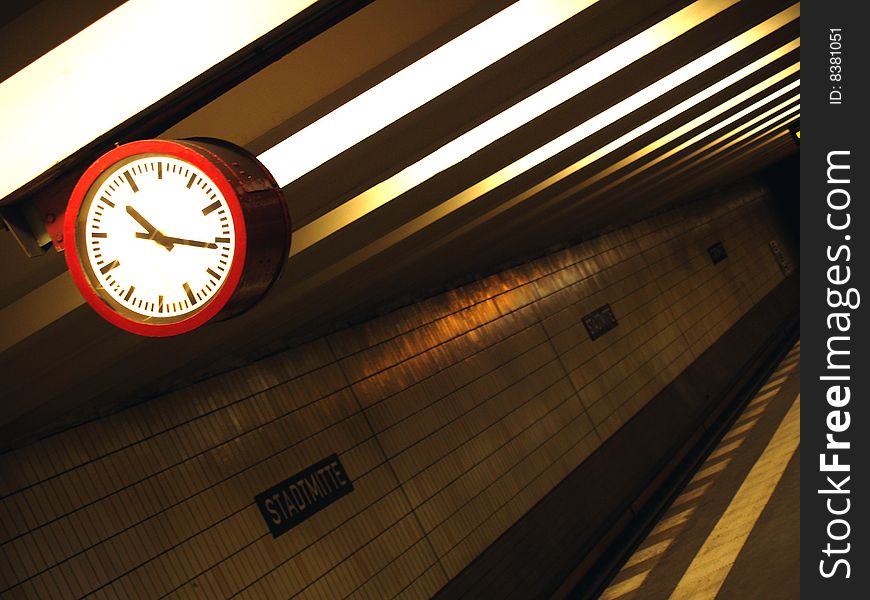 A red clock in the U2 subway station in Berlin Germany. A red clock in the U2 subway station in Berlin Germany.