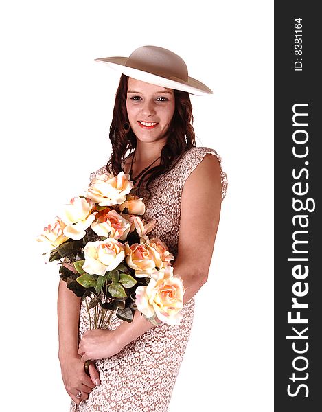 Beautiful lady in a beige dress and hat standing in the studio with yellow 
roses in her arm's smiling, for white background. Beautiful lady in a beige dress and hat standing in the studio with yellow 
roses in her arm's smiling, for white background.
