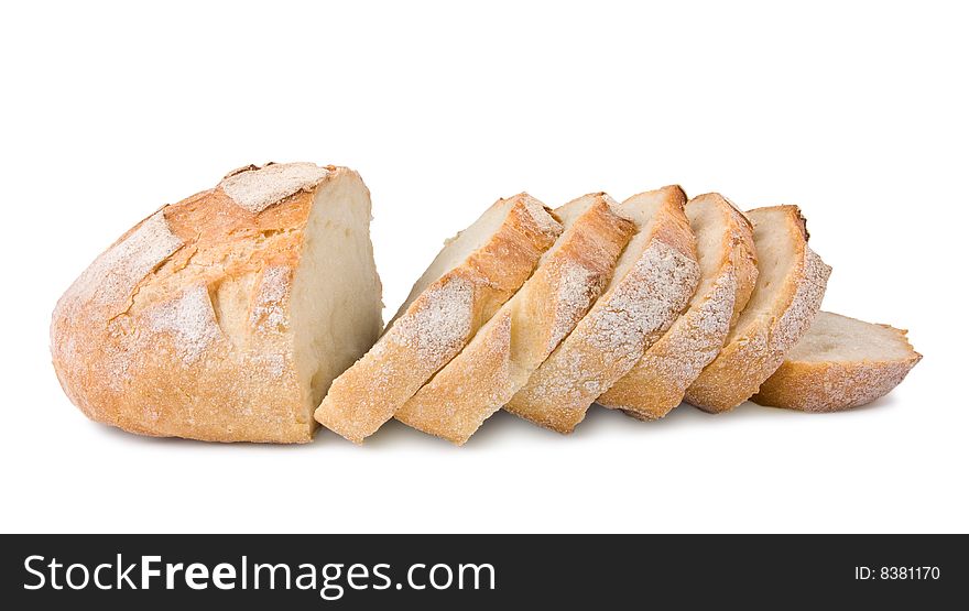 Fresh village bread cut on slices isolated at the white background