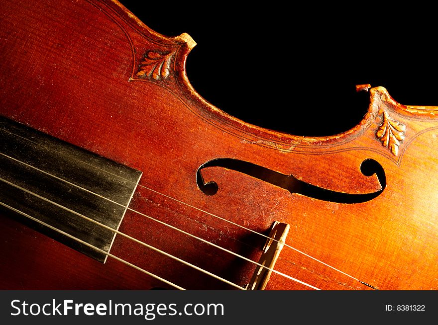 Part of vintage violin on black background