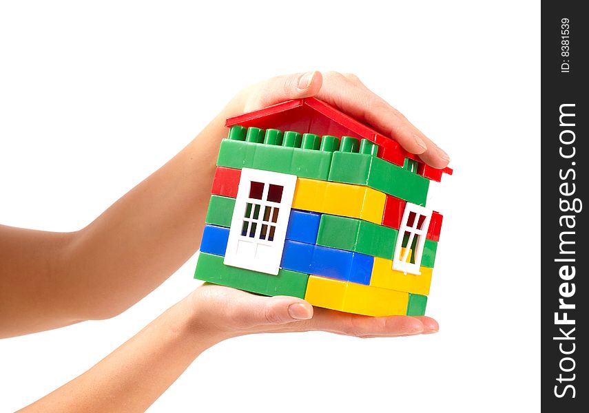 Small house in woman hands isolated on white