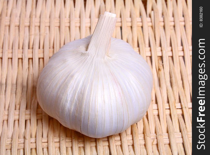 Healthy white vegetable pungent garlic on background