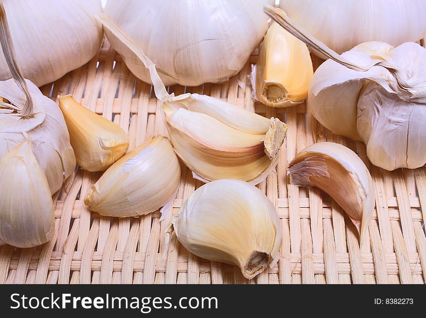 Healthy white vegetable pungent garlic on background