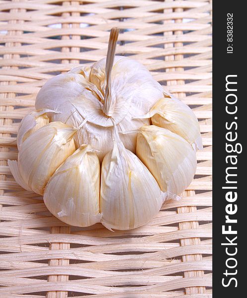 Healthy white vegetable pungent garlic on background