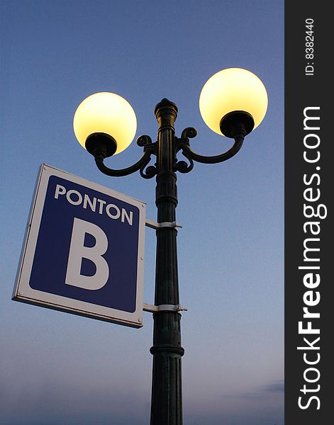 Street lamp with plate on pier