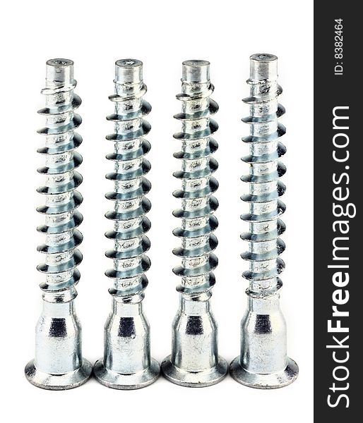 Four steel furniture screws standing vertical