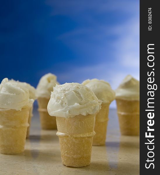 Group of small ice cream cones with blue background