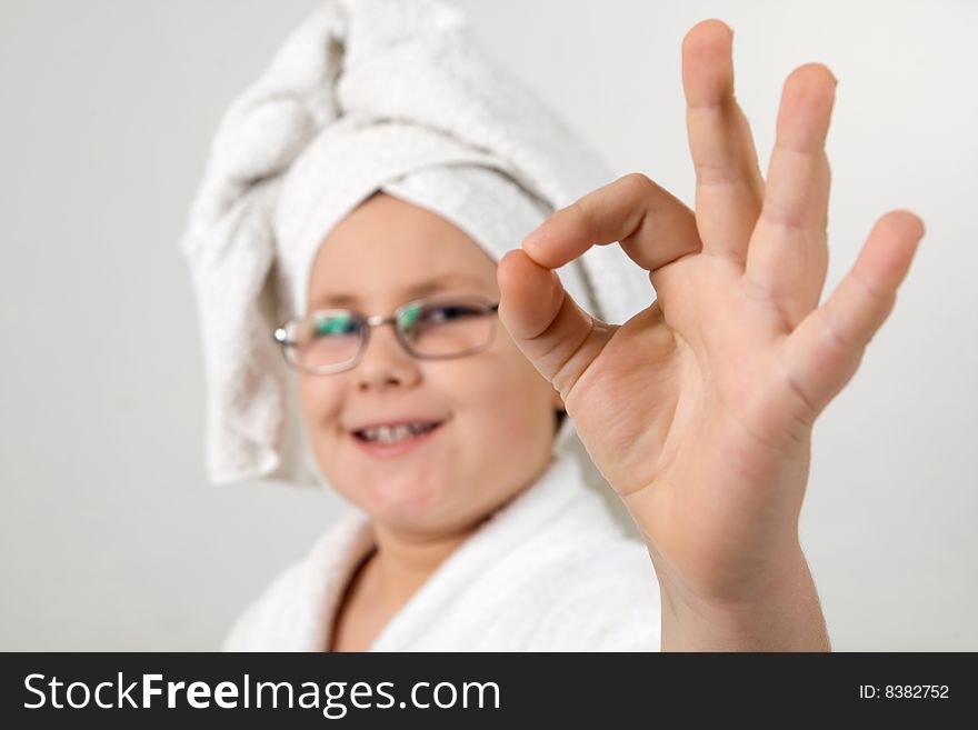 Funny looking kid with bathrobe and towel