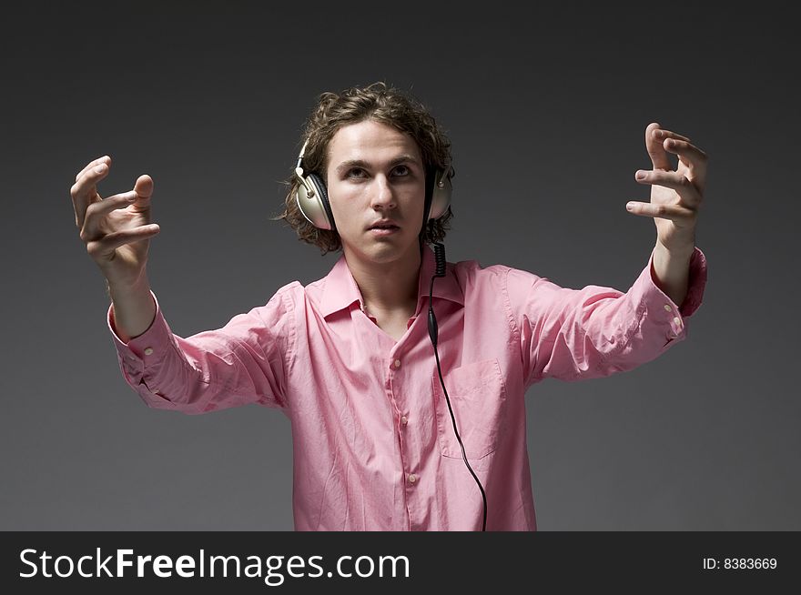 Young man listens on headphones music. Young man listens on headphones music