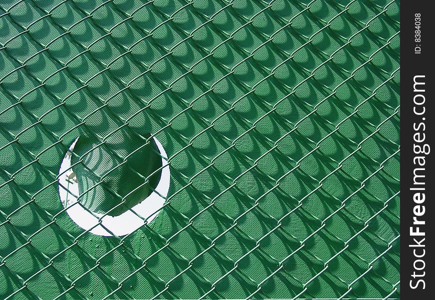 Detail of the typical fence at a tennis court. Detail of the typical fence at a tennis court