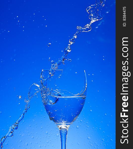Glass with Splashing water. Coolness Drink. Glass with Splashing water. Coolness Drink