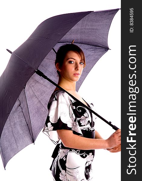 Side pose of young woman holding an umbrella against white background