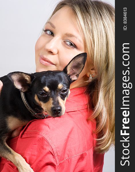 Young woman is embracing small dog (toy-terrier). Young woman is embracing small dog (toy-terrier)