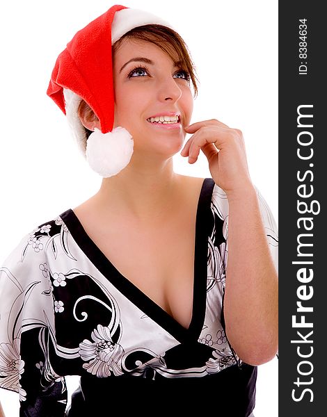 Front view of cheerful woman in christmas hat against white background