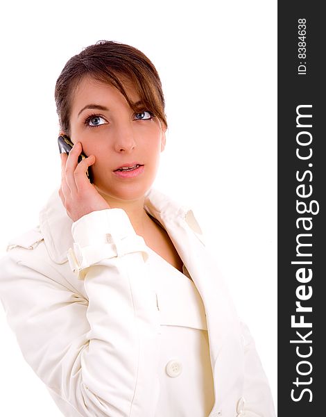 Side pose of fashionable woman talking on cellphone on an isolated white background