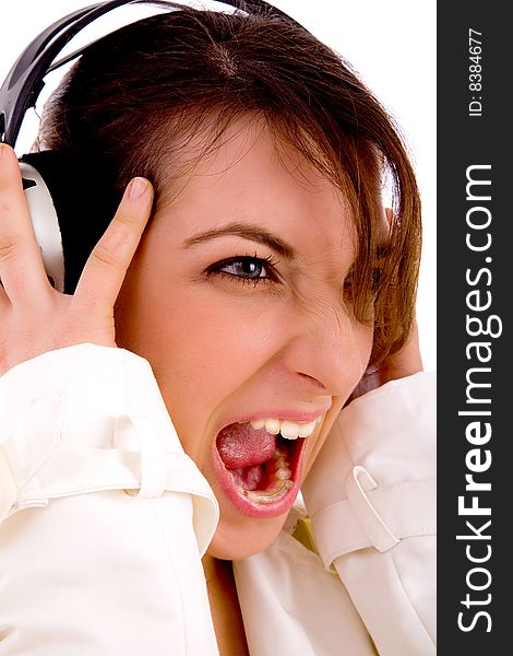 Side pose of screaming woman listening to music with white background