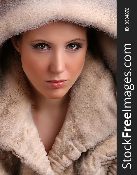 Portrait of attractive young woman wearing fur