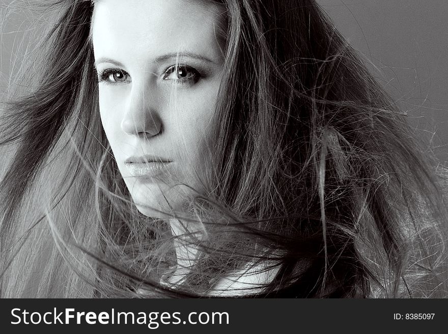 Attractive woman with flowing hair looking away from camera